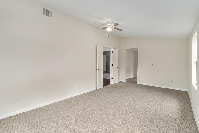 unfurnished room featuring carpet, lofted ceiling, and ceiling fan