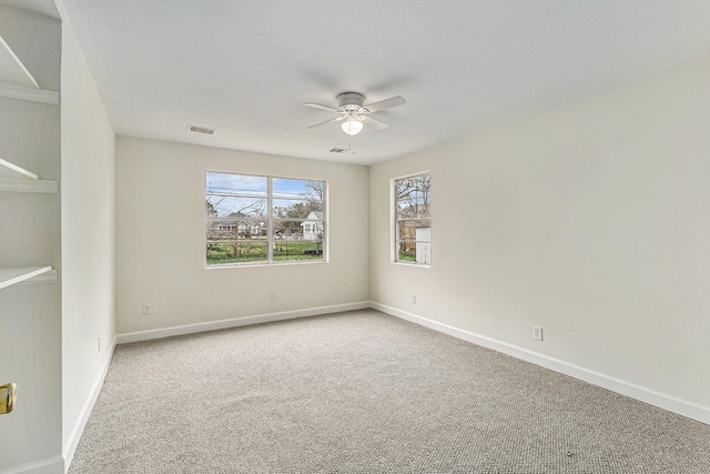 unfurnished room featuring ceiling fan and carpet flooring