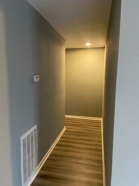 corridor featuring dark wood-type flooring