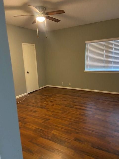 spare room featuring ceiling fan and dark hardwood / wood-style flooring