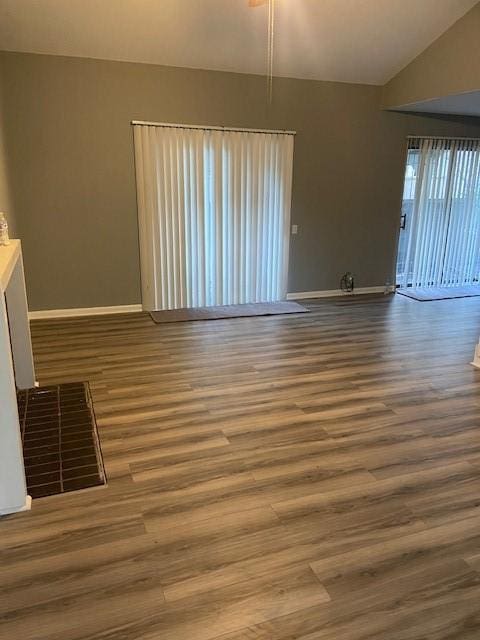 unfurnished living room with lofted ceiling and wood-type flooring