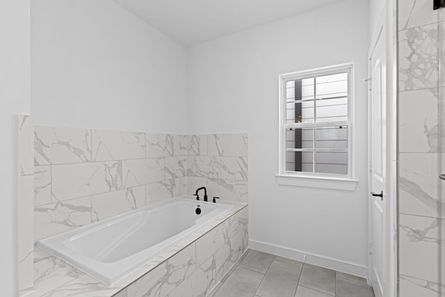 bathroom with tiled bath and tile patterned floors