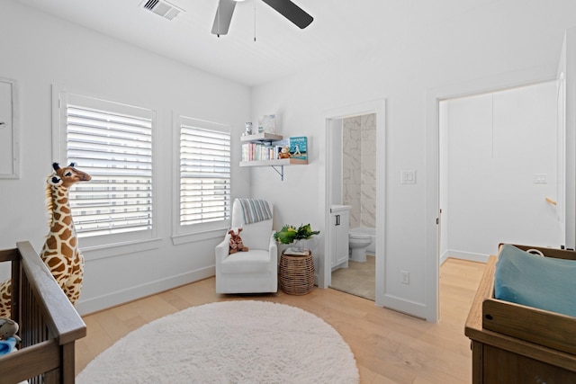 bedroom featuring ceiling fan, connected bathroom, and light hardwood / wood-style floors