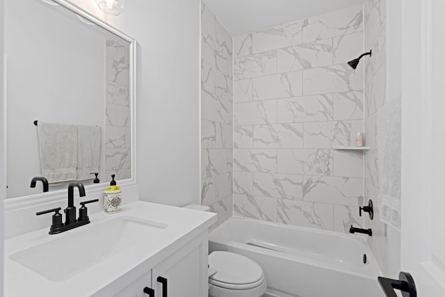 full bathroom featuring tiled shower / bath combo, vanity, and toilet