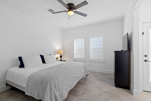 tiled bedroom with ceiling fan