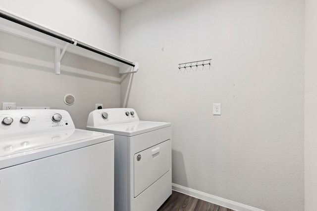 clothes washing area featuring dark hardwood / wood-style flooring and washing machine and dryer