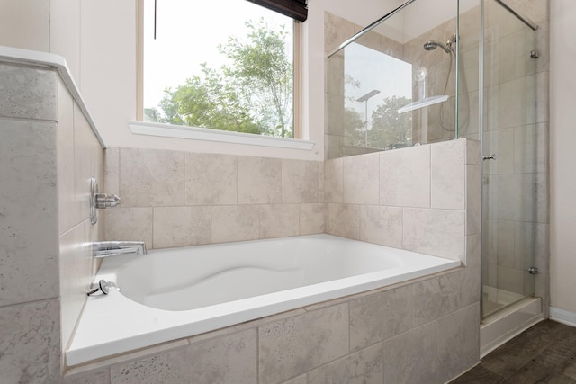 bathroom with independent shower and bath and hardwood / wood-style floors