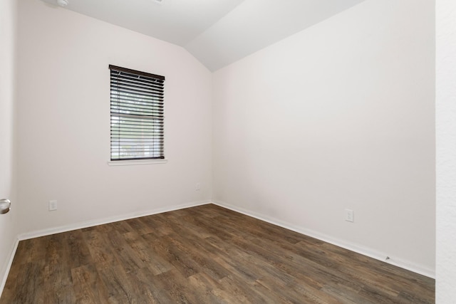 empty room with lofted ceiling and dark wood-type flooring