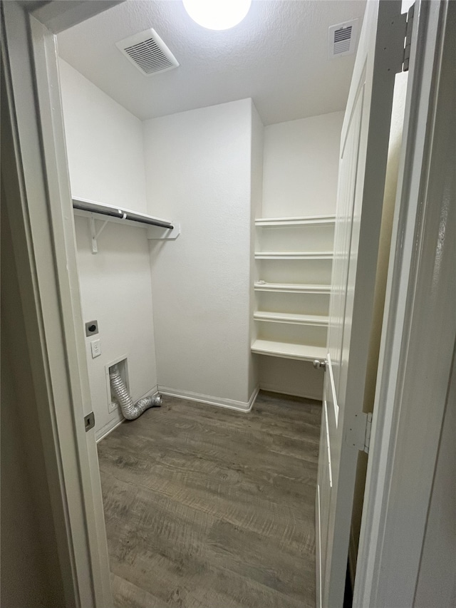 walk in closet featuring dark wood-type flooring