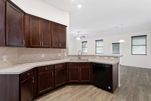 kitchen with sink, dishwasher, decorative light fixtures, kitchen peninsula, and light wood-type flooring