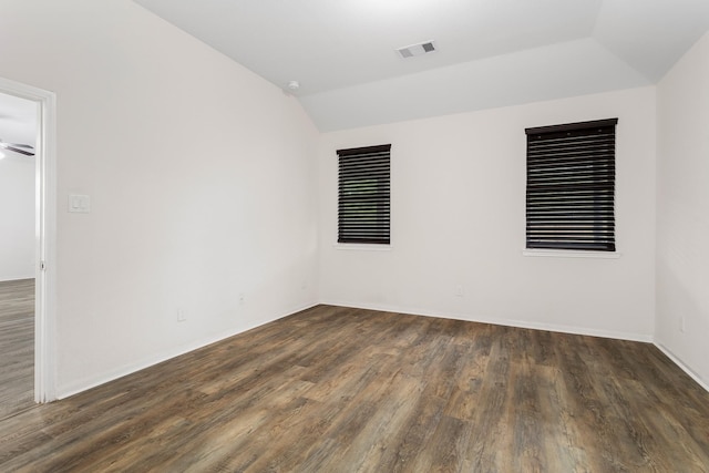 unfurnished room featuring dark hardwood / wood-style flooring and lofted ceiling