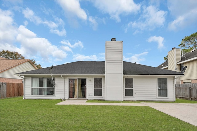 back of house with a yard and a patio area