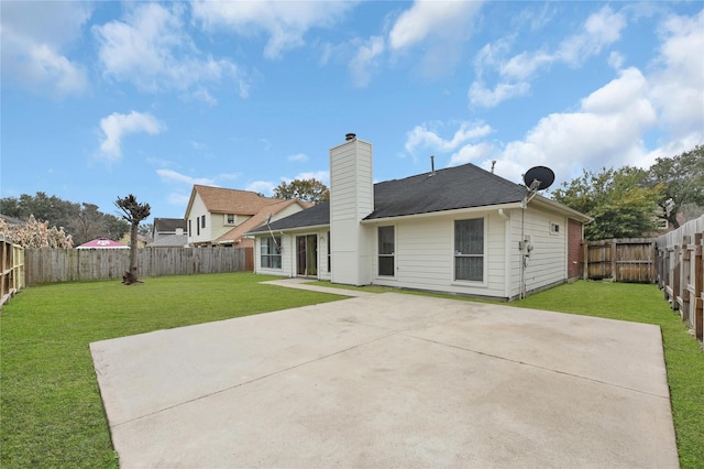 back of house featuring a yard and a patio area