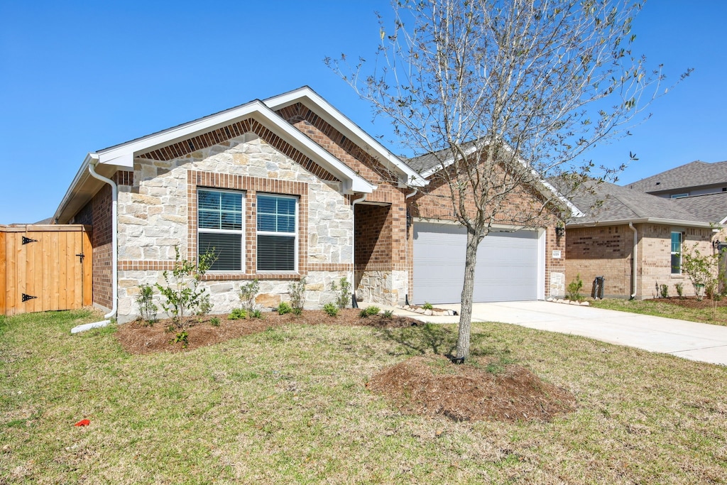 6319 Brazos Trail Dr, Richmond, TX 77469 - ranch-style house with stone siding, an attached garage, concrete driveway, and a front yard