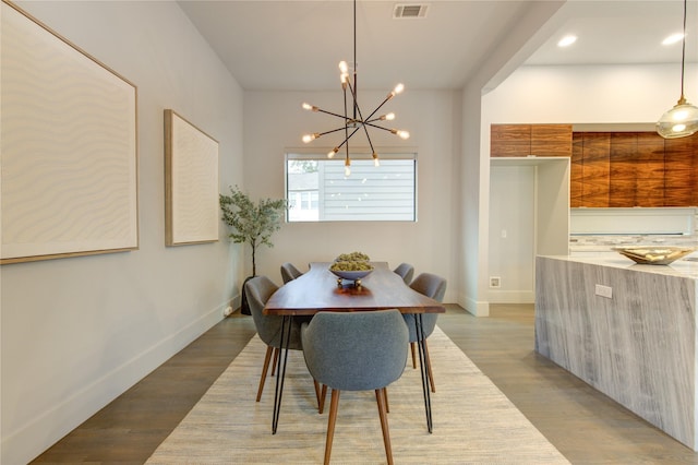 dining room with a chandelier and light hardwood / wood-style flooring