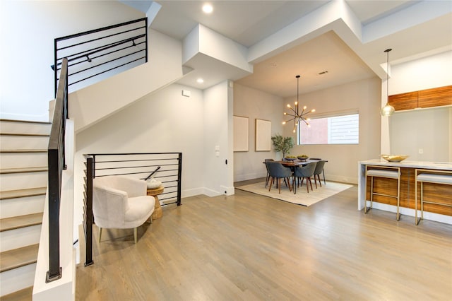 interior space featuring an inviting chandelier and light hardwood / wood-style floors