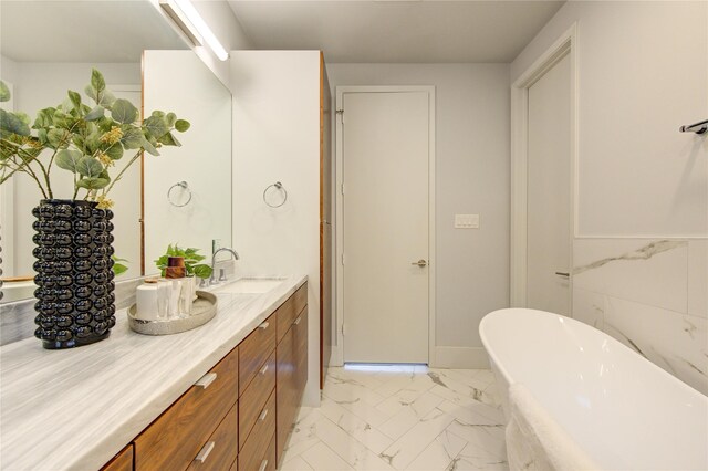 bathroom with vanity and a washtub