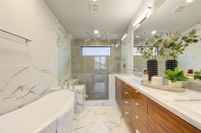 bathroom with independent shower and bath, vanity, and tile walls