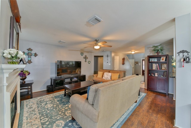 living room with ceiling fan and dark hardwood / wood-style flooring