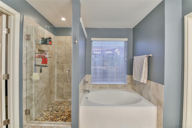 bathroom with separate shower and tub