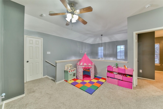 recreation room featuring lofted ceiling, light colored carpet, and ceiling fan