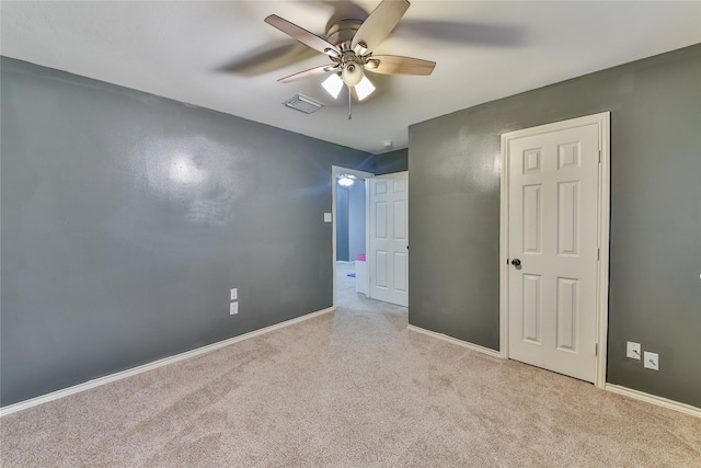 unfurnished bedroom with ceiling fan and light carpet