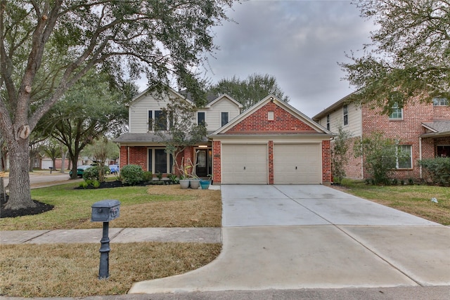 view of front of property with a garage and a front lawn