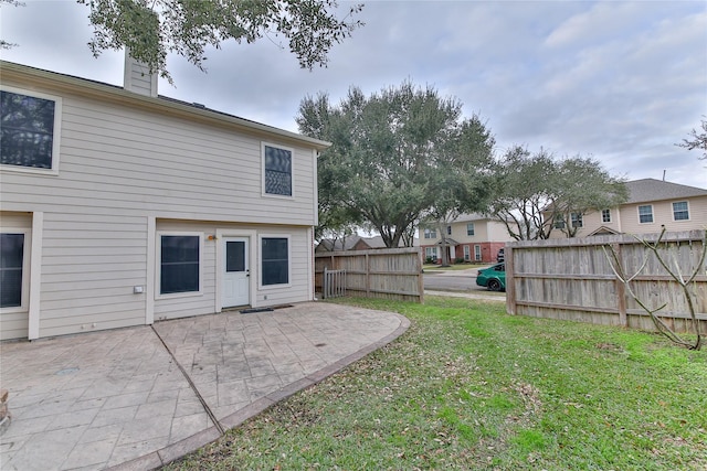 back of house featuring a yard and a patio area