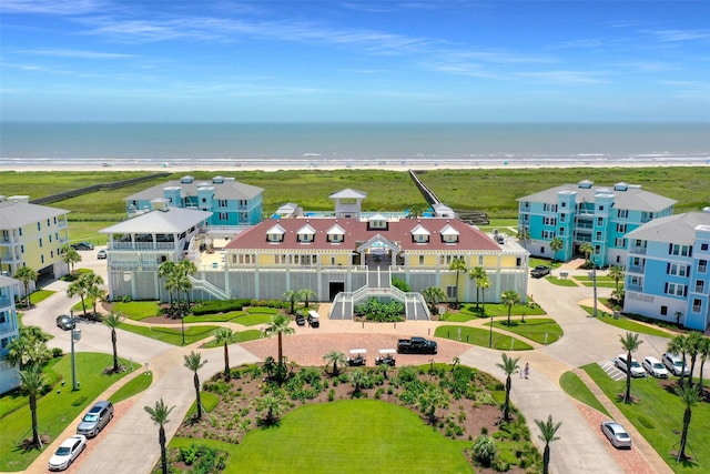 birds eye view of property with a beach view and a water view