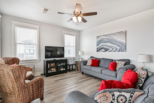 living room with light hardwood / wood-style floors and ceiling fan