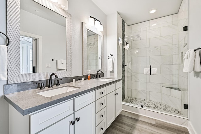 4241 Pointe W Dr, Galveston, TX 77554 - bathroom with a shower stall, wood finished floors, recessed lighting, and double vanity