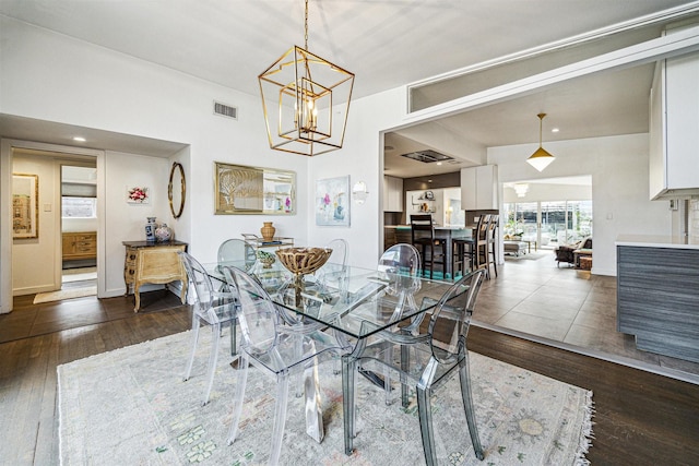 dining area featuring a notable chandelier and dark hardwood / wood-style floors