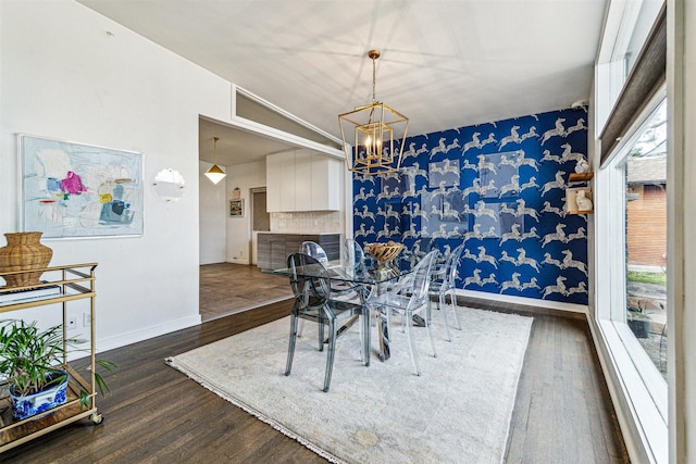 dining area featuring vaulted ceiling, dark hardwood / wood-style floors, and a notable chandelier