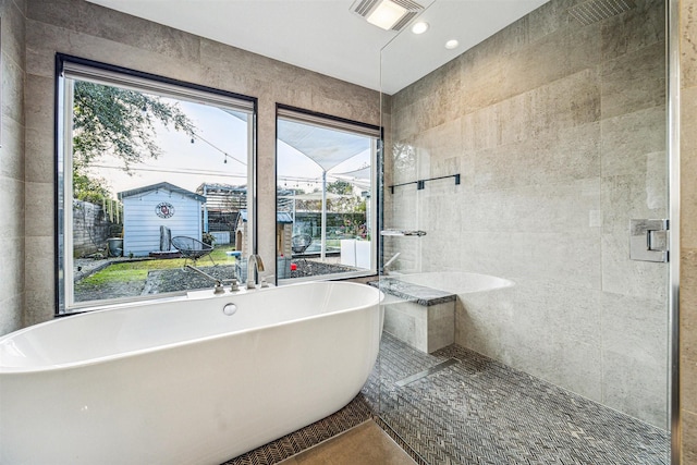 bathroom with tile walls and a washtub