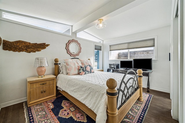 bedroom with lofted ceiling with beams and dark hardwood / wood-style flooring