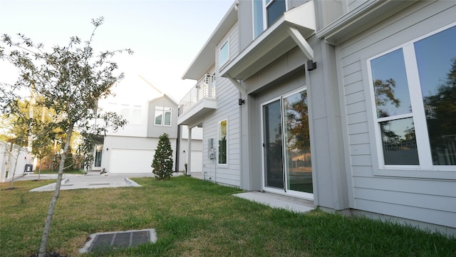 view of home's exterior featuring a garage and a yard