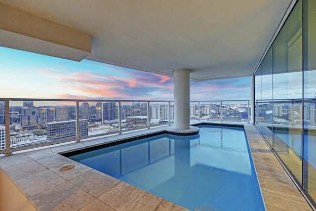 view of pool at dusk