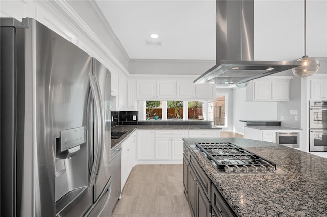 kitchen featuring white cabinets, decorative backsplash, appliances with stainless steel finishes, ornamental molding, and island exhaust hood