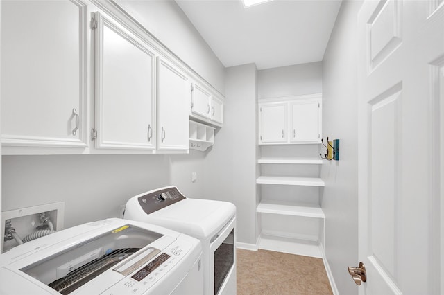 clothes washing area featuring cabinet space, light tile patterned floors, baseboards, and washer and dryer