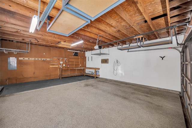 garage featuring electric panel and a garage door opener