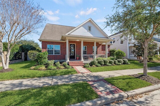 view of front of house with a porch and a front lawn