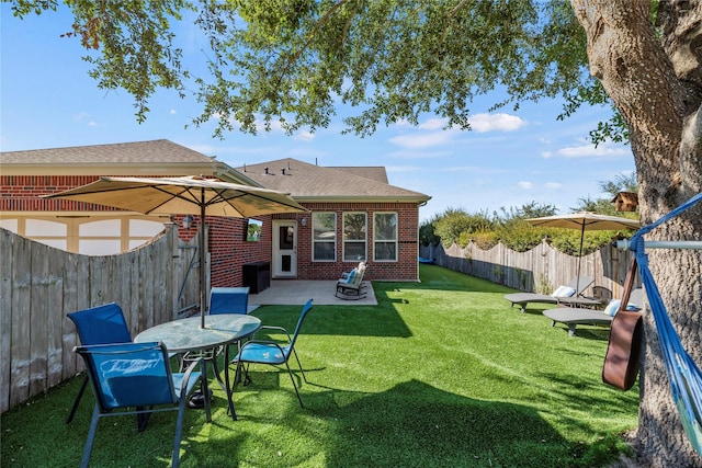 rear view of property featuring a patio area and a lawn