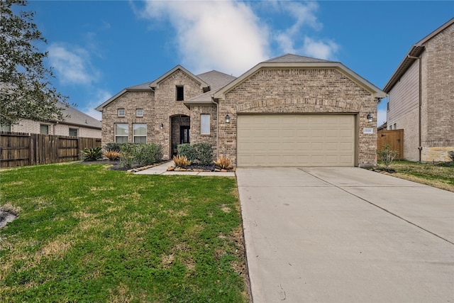 view of front of home with a garage and a front lawn