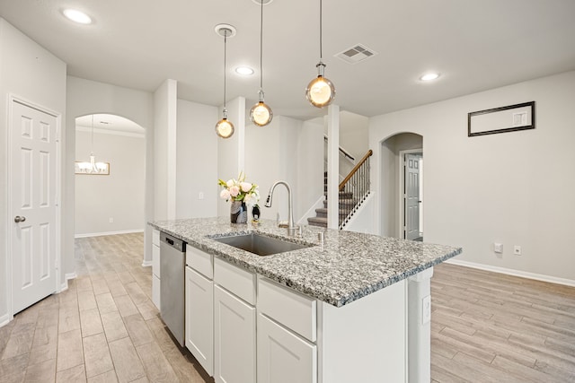 kitchen with sink, light hardwood / wood-style flooring, dishwasher, white cabinetry, and light stone counters