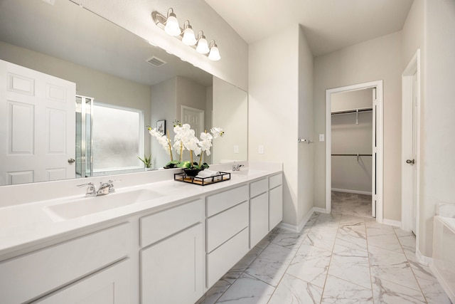 bathroom featuring vanity and a tub to relax in