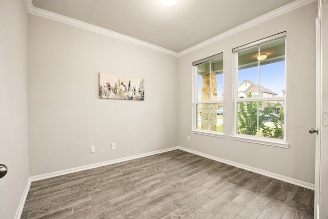 spare room featuring crown molding and wood-type flooring