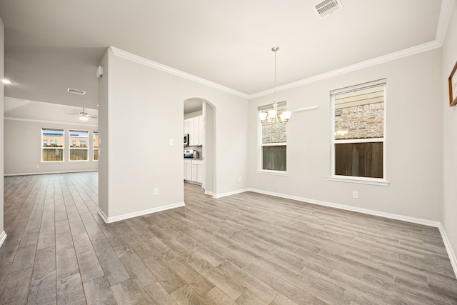 spare room featuring hardwood / wood-style flooring, crown molding, and ceiling fan with notable chandelier