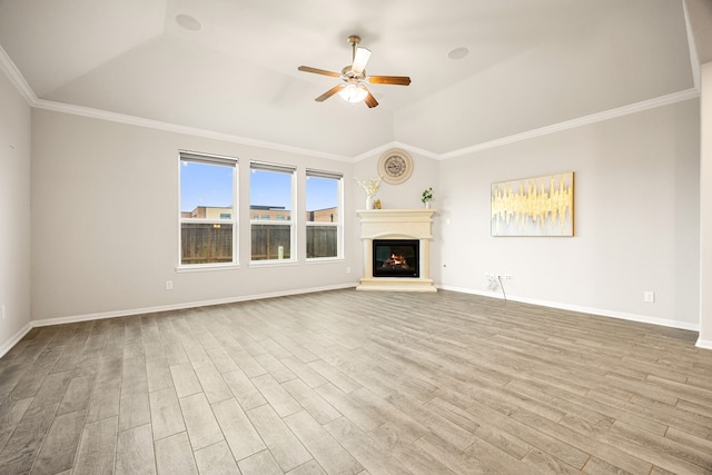 unfurnished living room with ceiling fan, vaulted ceiling, crown molding, and light hardwood / wood-style floors