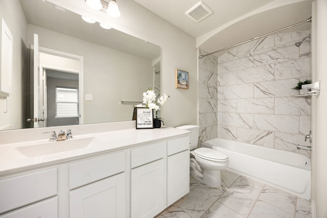 full bathroom featuring vanity, tiled shower / bath combo, and toilet