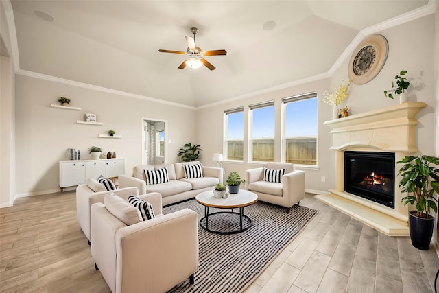 living room featuring ceiling fan, ornamental molding, lofted ceiling, and light hardwood / wood-style flooring